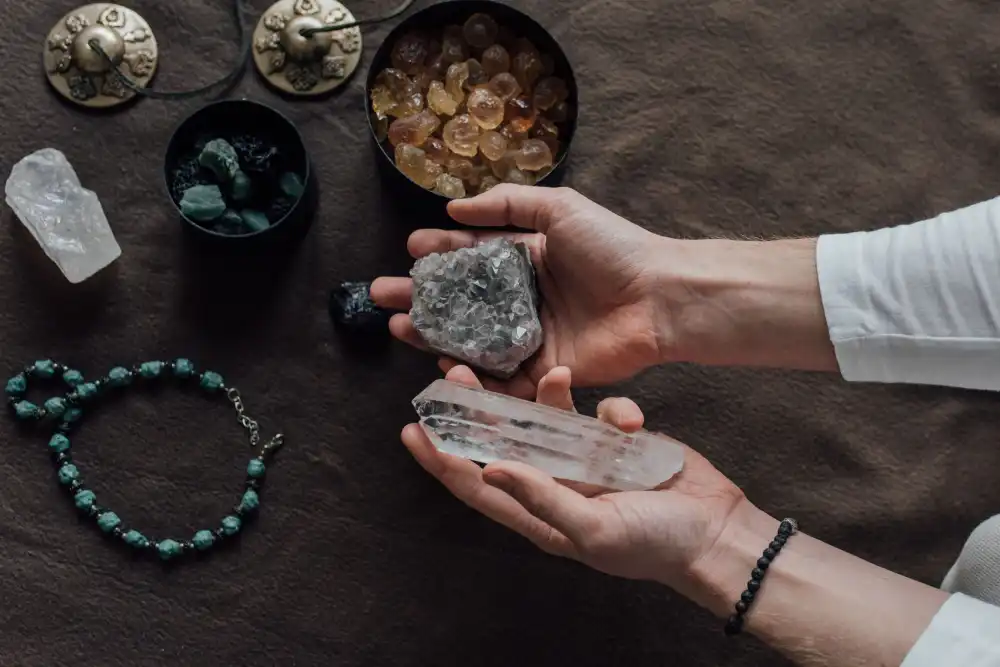 Hands selecting crystals in an intentional space